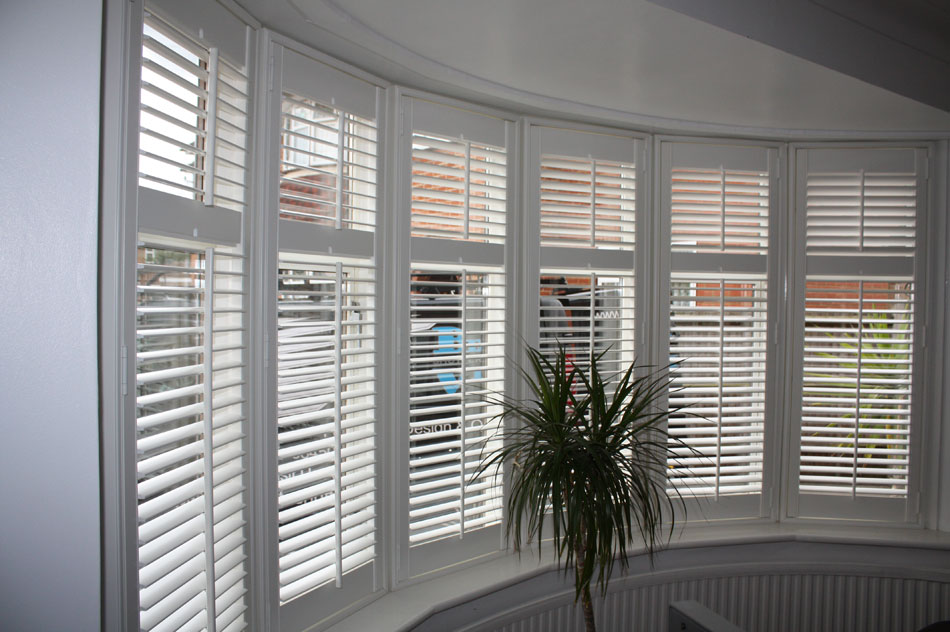 Wood Shutters fitted on a Bay Window with Mid Rail